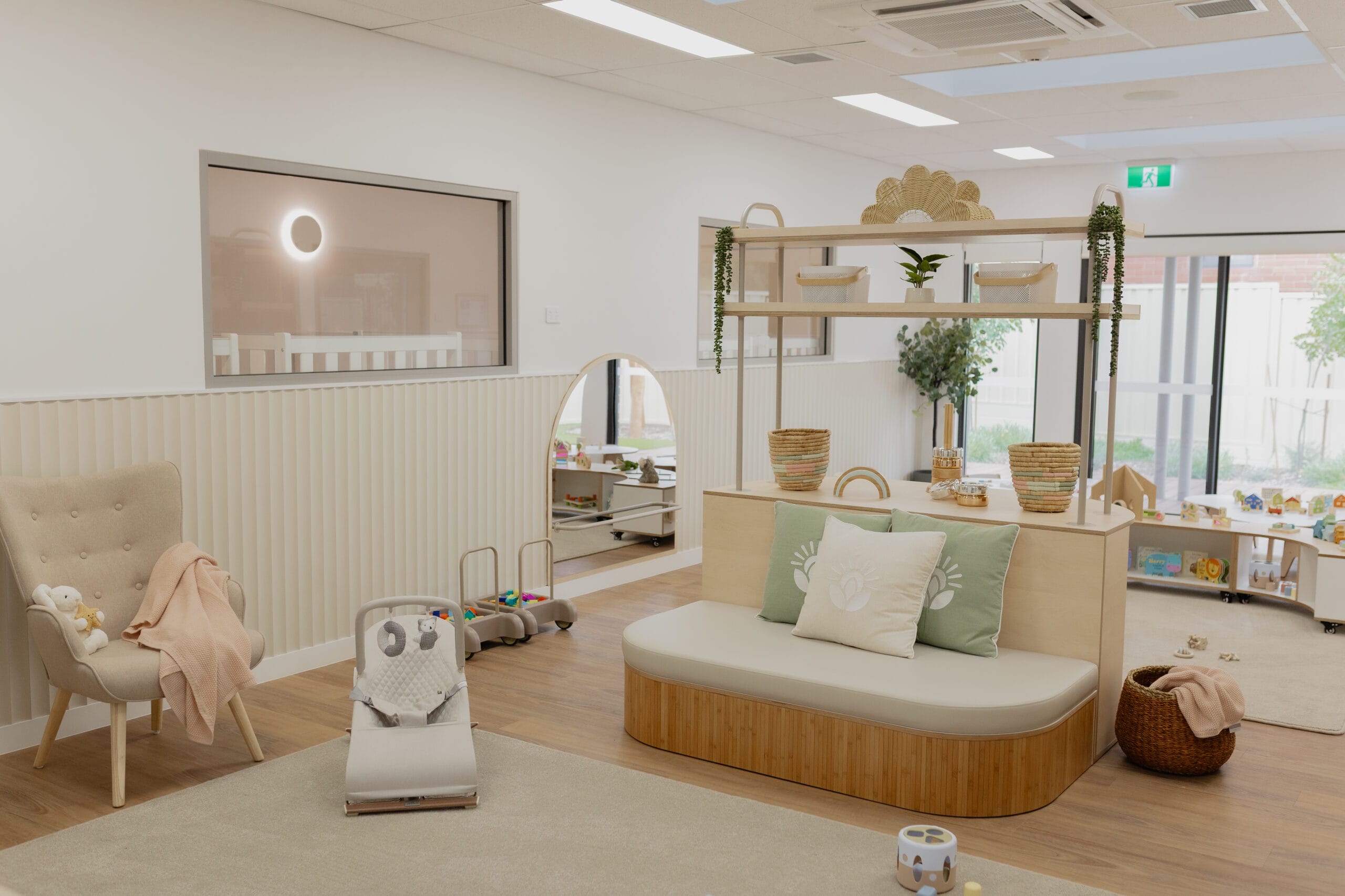 The empty Stars Room lounge area with cozy furniture and baskets of toys